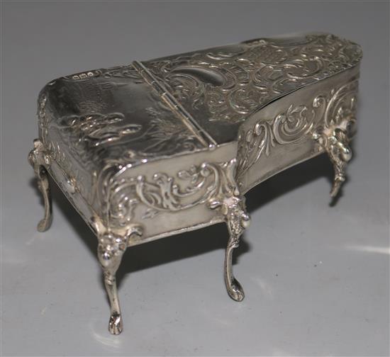An early 20th century German Hanau repousse silver box, in the form of a miniature piano with Import marks for London, 1900.